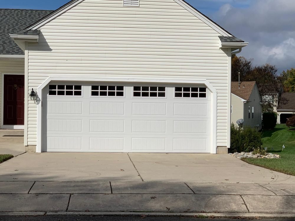 White carriage-style garage door with windows on a home