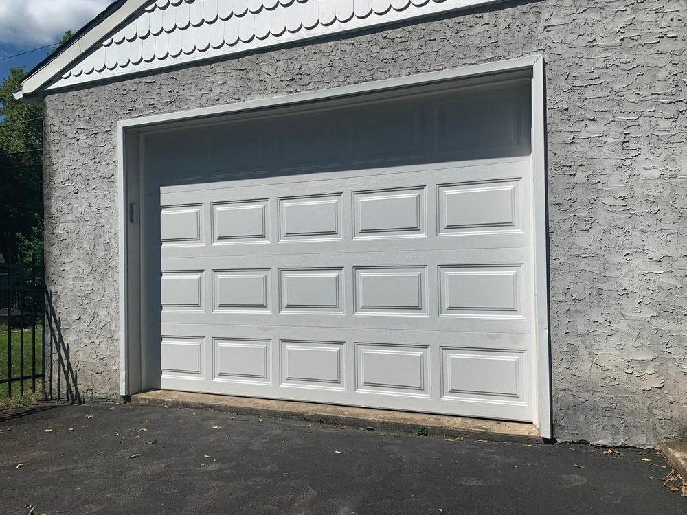 Classic white raised-panel garage door installation